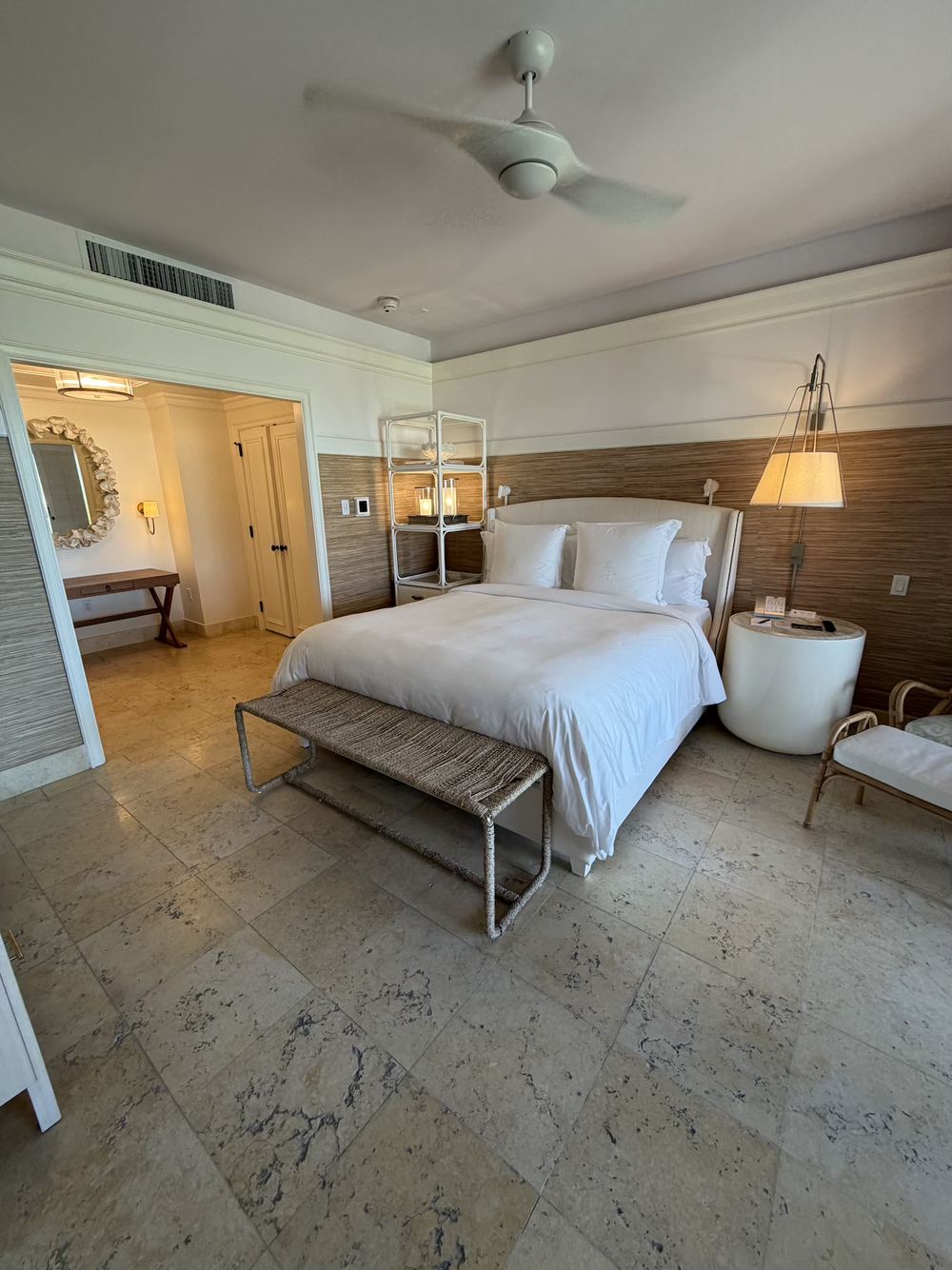 A bright hotel bedroom with ocean views